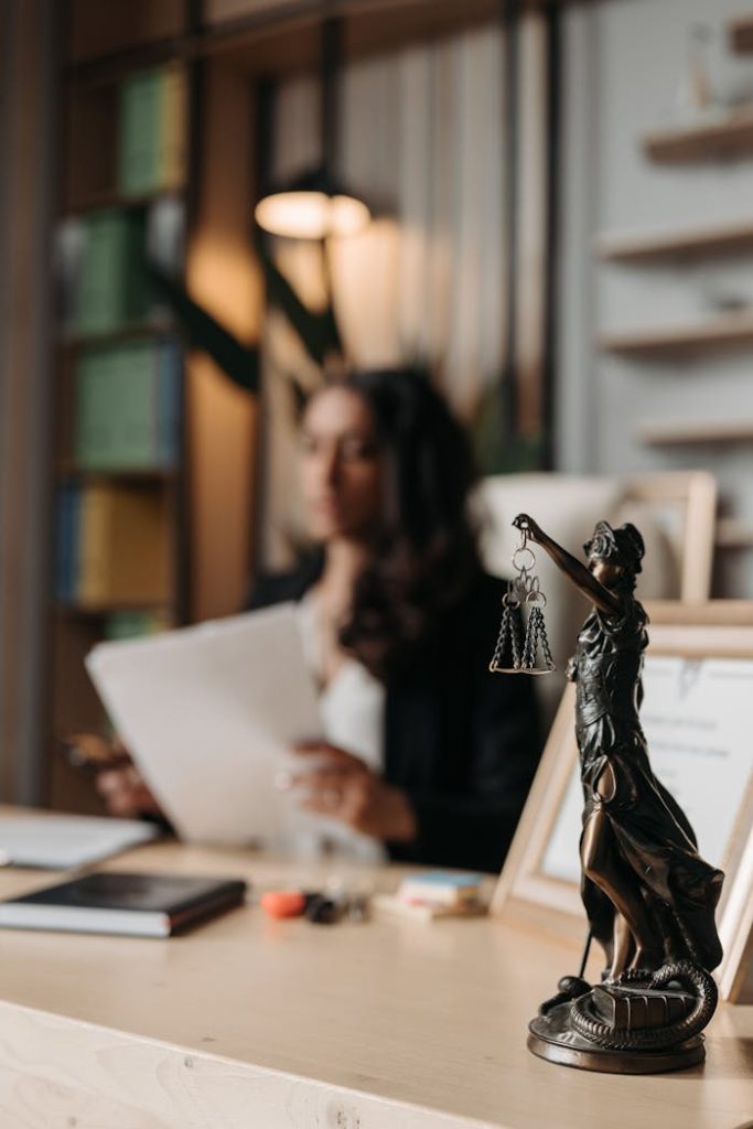 figurine-of-justice-on-table-in-office-8111815