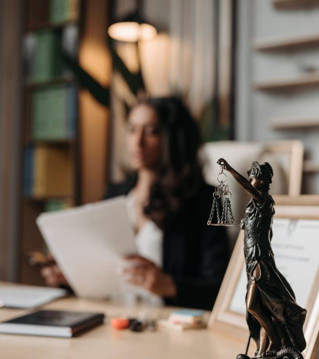 figurine-of-justice-on-table-in-office-8111815